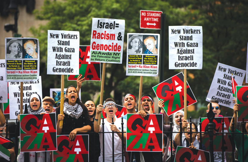 ANTI-ISRAEL DEMONSTRATORS display signs outside of New York City Hall in 2014. (credit: LUCAS JACKSON/REUTERS)