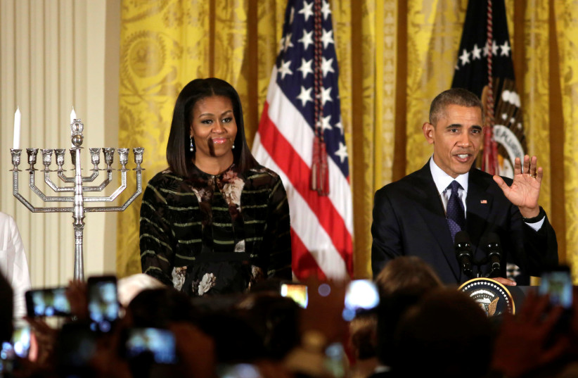 US President Barack Obama speaks next to First lady Michelle Obama at a Hanukkah reception at the White House in Washington, US, December 14, 2016. (photo credit: REUTERS)
