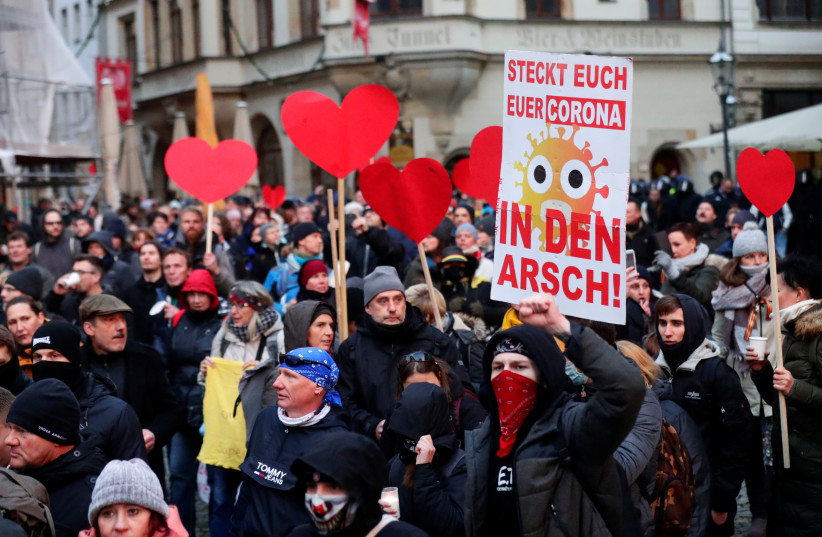 Protestors attend a demonstration of coronavirus skeptics, amid the coronavirus disease (COVID-19) outbreak in Leipzig, Germany November 21, 2020 (photo credit: HANNIBAL HANSCHKE/REUTERS)