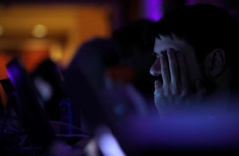 A man takes part in a hacking contest during the Def Con hacker convention in Las Vegas, Nevada, U.S. on July 29, 2017. (photo credit: REUTERS)