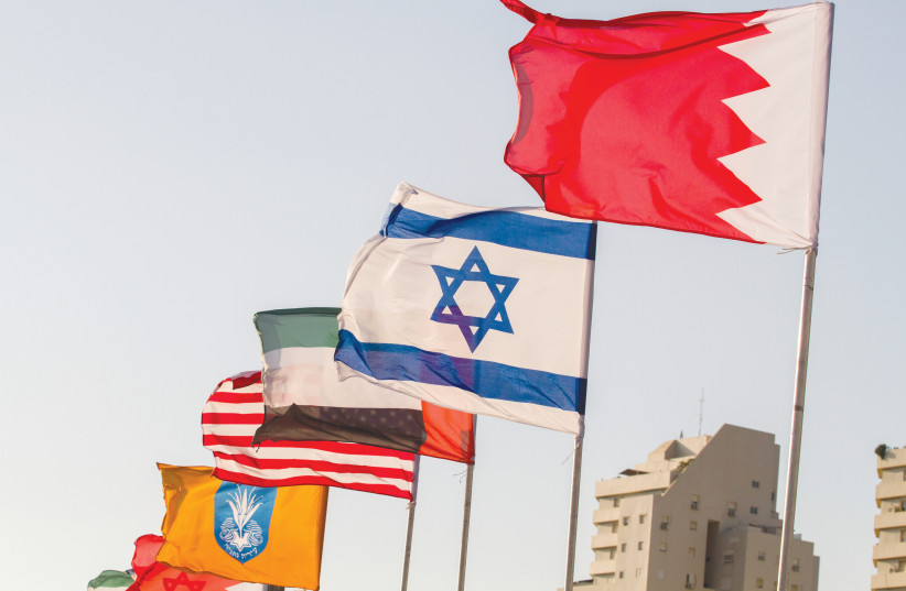 THE FLAGS of the US, United Arab Emirates, Israel and Bahrain are seen on the side of a road in Netanya, in September. (credit: FLASH90)