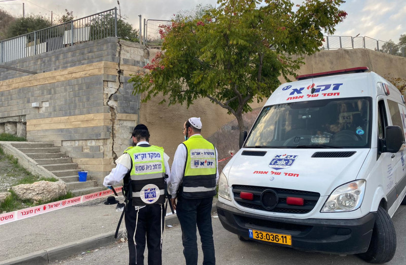 ZAKA medics are seen in Beit Shemesh, where a fence broke, leading a 13-year-old boy to fall to his death. (photo credit: KOBI LIZROVITZ)