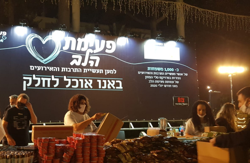 Members of the Heartbeat Association preparing food baskets for culture and events workers in Rabin Square in Tel Aviv on Monday. (photo credit: HEARTBEAT ASSOCIATION)