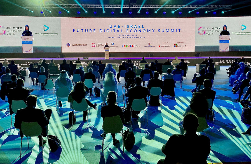 Delegates attend a digital conference held by Israel and UAE, in Dubai, United Arab Emirates, December 7, 2020. (photo credit: REUTERS/ABDEL HADI RAMAHI)