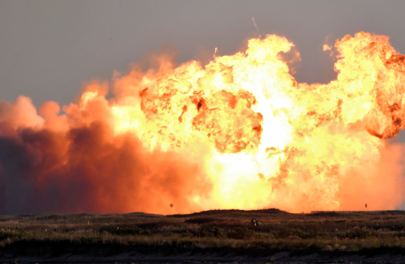 SpaceX's first super heavy-lift Starship SN8 rocket explodes during a return-landing attempt after it launched from their facility on a test flight in Boca Chica, Texas US. December 9, 2020. (photo credit: GENE BLEVINS / REUTERS)