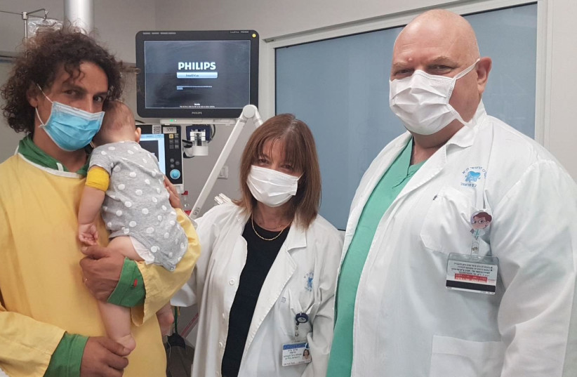 Prof. Galia Grisaru and Dr. Efraim Sadot with Mika, an infant they treated for a life-threatening infection. (photo credit: REVITAL ANAVA/ICHILOV HOSPITAL)