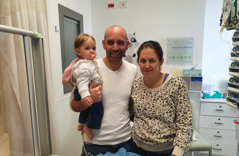 The 8-month-old with her parents after receeiving medical care, Assuta Ashdod Hospital (photo credit: Courtesy)