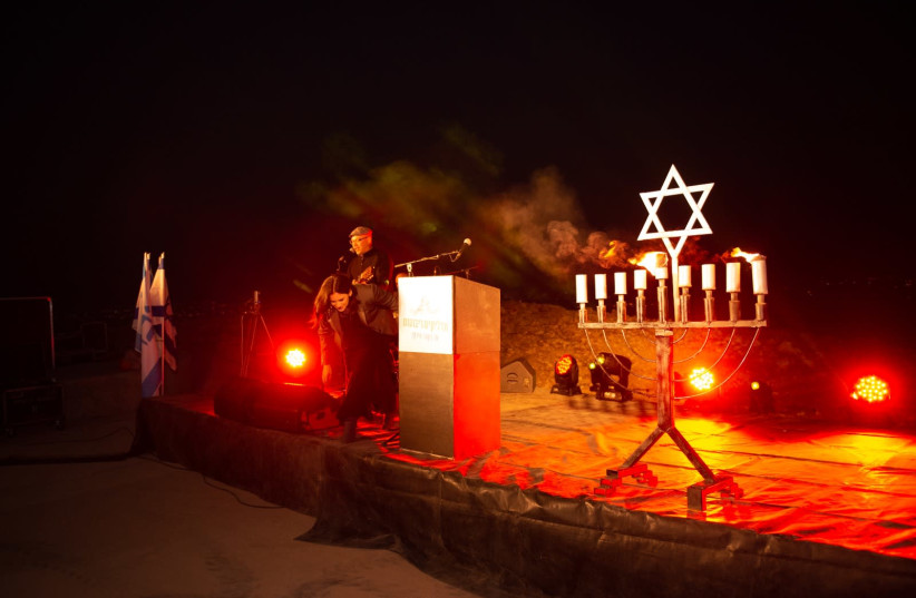The candles are lit on stage for a Hanukkah ceremony held virtually in the Jordan Valley. (photo credit: MEIR ELIPOUR)