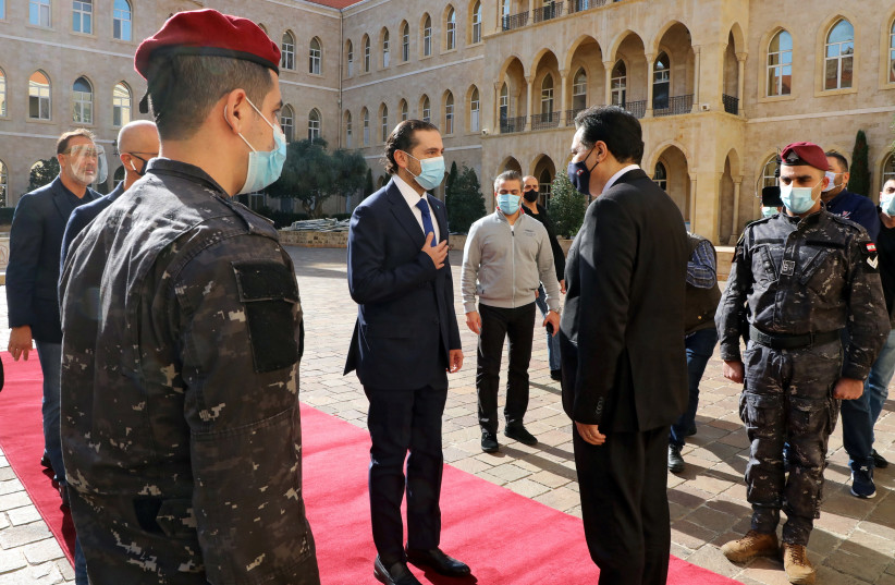 Lebanon's Prime Minister-designate Saad al-Hariri is greeted by Lebanon's caretaker Prime Minister Hassan Diab at the governemt palace in Beirut, Lebanon, December 11, 2020.  (photo credit: REUTERS)