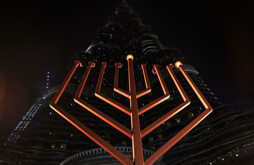 A giant menorah is lit up to celebrate Hanukkah, the Jewish festival of lights, in Dubai, United Arab Emirates December 10, 2020. (photo credit: REUTERS)