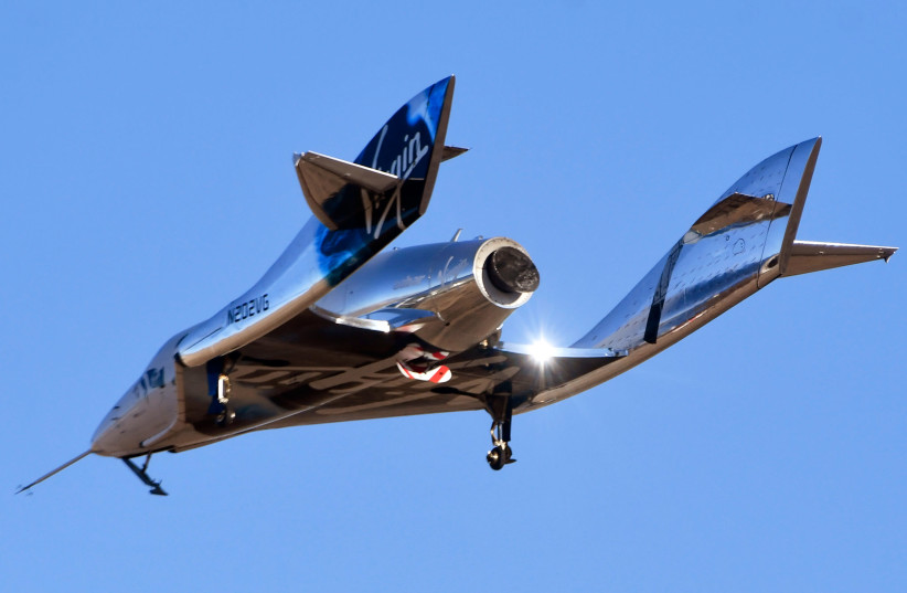 Virgin Galactic’s space tourism rocket plane SpaceShipTwo returns after a test flight from Mojave Air and Space Port in Mojave, California, U.S. December 13, 2018.  (photo credit: GENE BLEVINS / REUTERS)