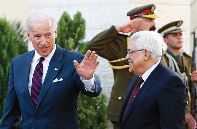THEN-US vice president Joe Biden gestures as he walks with Palestinian Authority President Mahmoud Abbas after their meeting in Ramallah in 2010. (credit: REUTERS)
