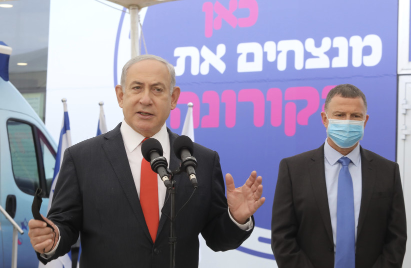 Prime Minister Benjamin Netanyahu and Health Minister Yuli Edelstein tour Maccabi vaccination complex, Tel Aviv, December 13, 2020 (photo credit: MARC ISRAEL SELLEM/THE JERUSALEM POST)