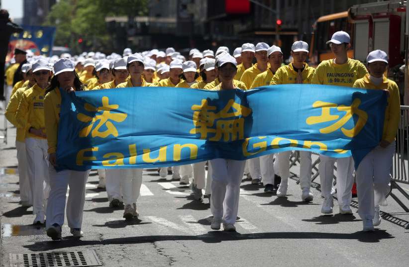 Members of Falun Gong or Falun Dafa, a Chinese religious spiritual practice, march to the Consulate General of the People's Republic of China in New York City, US, May 16, 2019.  (photo credit: REUTERS/SHANNON STAPLETON)
