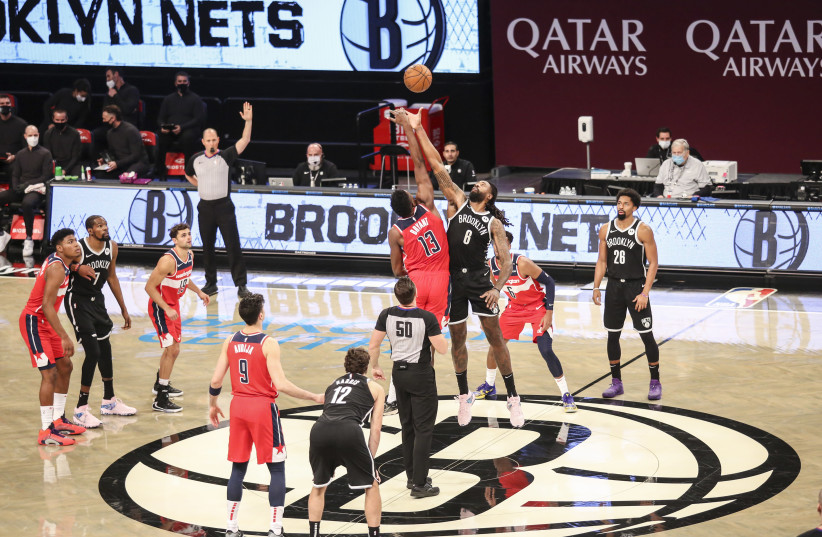 DENI AVDIJA (number 9) is on the court in the Washington Wizards starting line-up for the tip-off of Sunday's night preseason game against the Brooklyn Nets. The Israeli rookie finished with 15 points in his NBA debut (photo credit: REUTERS)