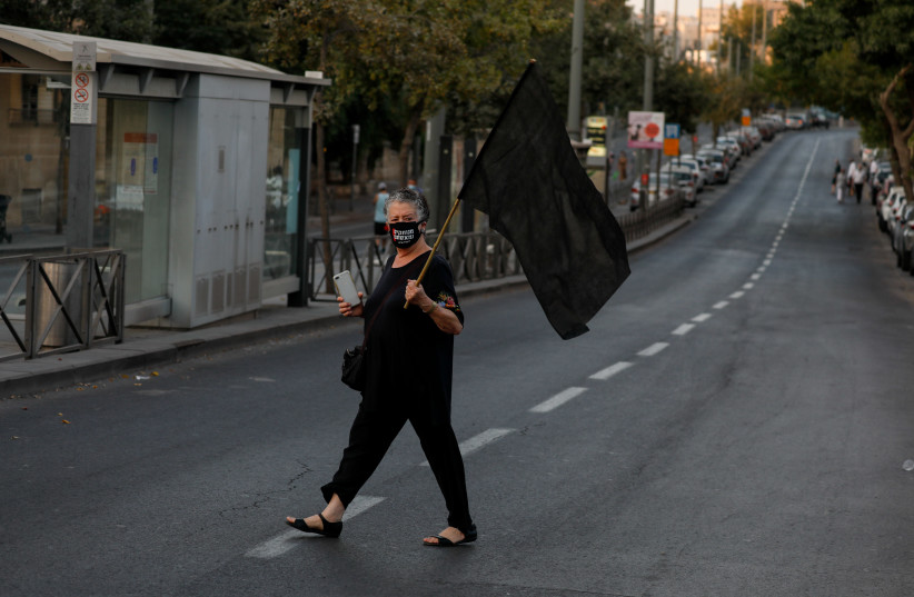 Israelis protest against Israeli prime minister Benjamin Netanyahu, at Beit HaKerem neighborhood in Jerusalem on October 10, 2020.  (photo credit: OLIVIER FITOUSSI/FLASH90)