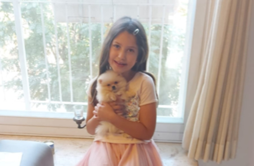 The writer’s granddaughter with Fluffy (photo credit: Courtesy)