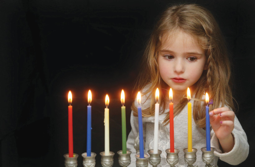 WE LIGHT a candle of hope and possibilities as we light the menorah. (photo credit: MARC ISRAEL SELLEM/THE JERUSALEM POST)