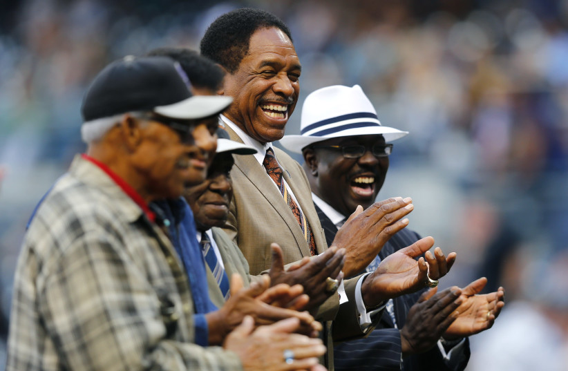 Dave Winfield (C), Executive Vice President/Senior Advisor of the San Diego Padres, shares a moment with former players from the Negro Leagues during a pre-game ceremony before the San Diego Padres hosted the Toronto Blue Jays for an interleague Major League Baseball game in San Diego, California Ma (photo credit: MIKE BLAKE/REUTERS)