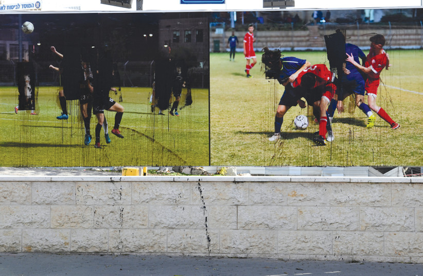 A exhibition in Jerusalem showcasing women's soccer was instead found vandalized, December 2020 (photo credit: ALMA MACHNESS-KASS)