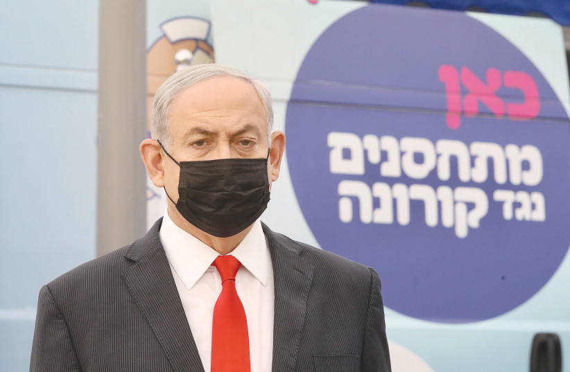 PRIME MINISTER Benjamin Netanyahu at a Maccabi vaccine center in Tel Aviv on Sunday. (photo credit: MARC ISRAEL SELLEM/THE JERUSALEM POST)