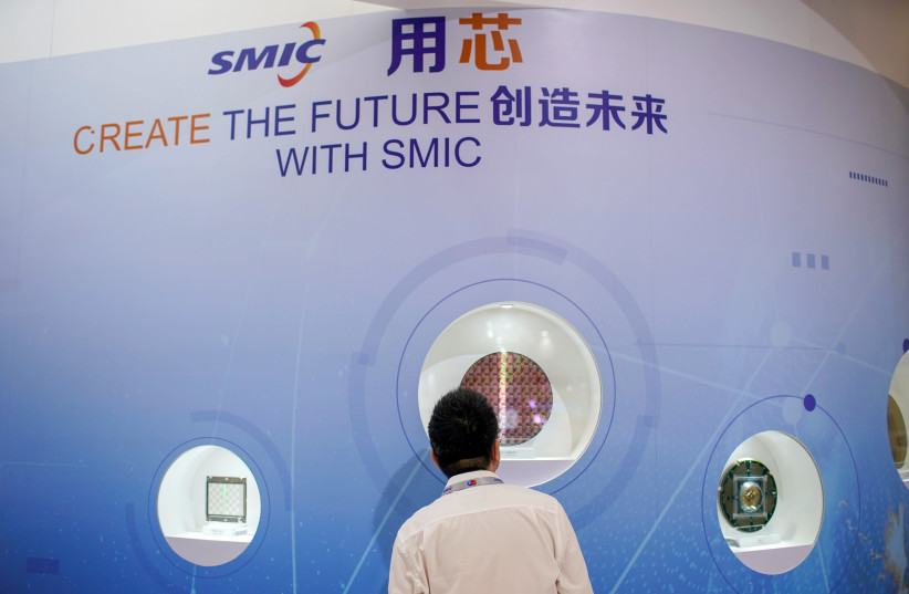 A man visits a booth of Semiconductor Manufacturing International Corporation (SMIC), at China International Semiconductor Expo (IC China 2020) following the coronavirus disease (COVID-19) outbreak in Shanghai, China October 14, 2020 (photo credit: REUTERS/ALY SONG)