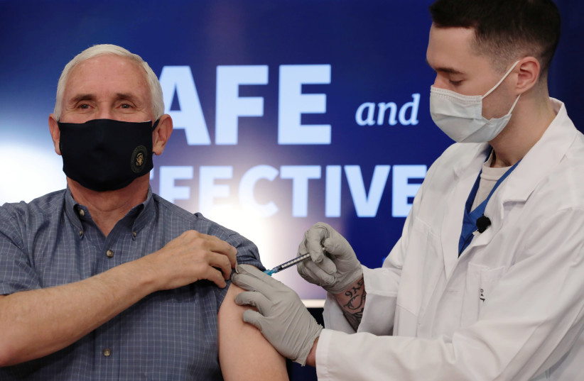 US Vice President Mike Pence receives the COVID-19 vaccine at the White House in Washington. (photo credit: CHERISS MAY/REUTERS)