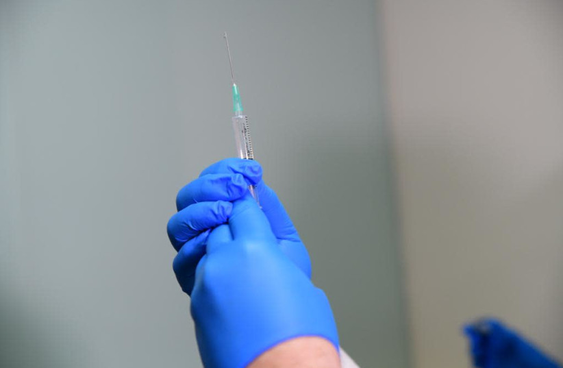 Coronavirus vaccines being prepared at Sourasky Medical Center, December 20, 2020 (photo credit: AVSHALOM SASSONI/ MAARIV)