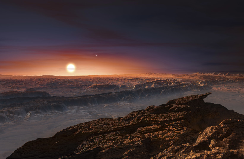 A view of the surface of the planet Proxima b orbiting the red dwarf star Proxima Centauri, the closest star to our Solar System, is seen in an undated artist's impression released by the European Southern Observatory August 24, 2016. (credit: ESO/M. KORNMESSER/HANDOUT VIA REUTERS)