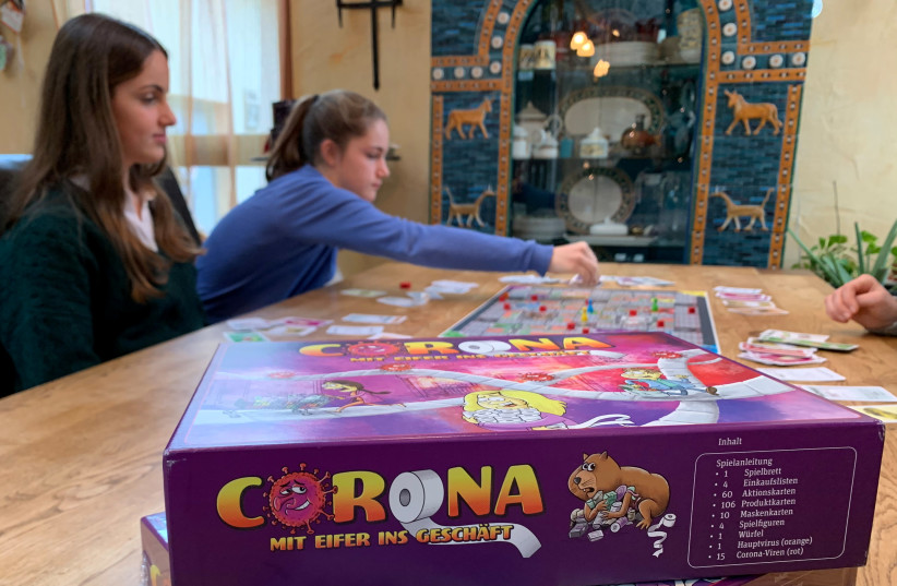 Sisters invent corona-virus board-game to play in Christmas shutdown (photo credit: ANNKATHRIN WEISS/REUTERS)