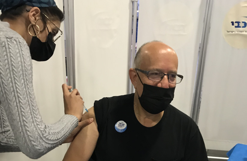 The Jerusalem Post's David Brinn gets vaccinated for coronavirus, December 24, 2020 (photo credit: DEBI RUBIN)
