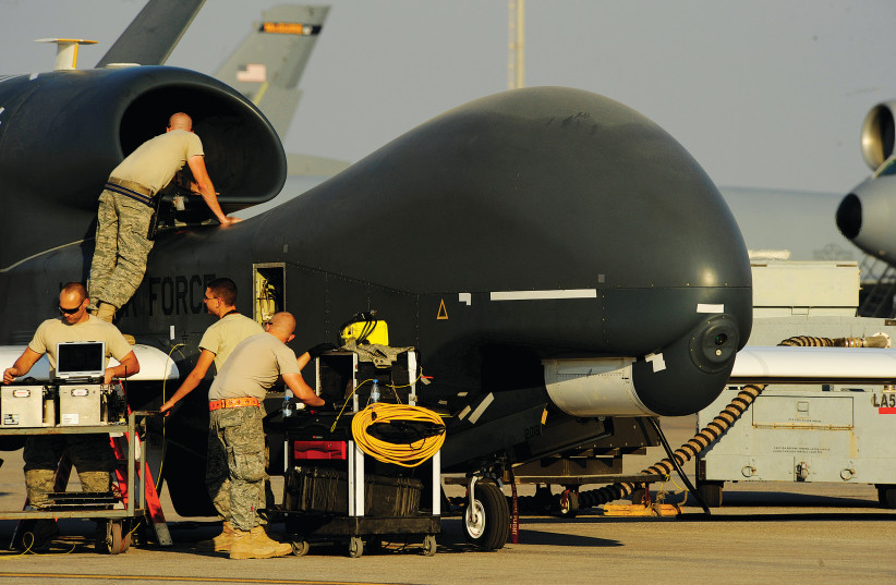 US AIR FORCE maintainers prepare a US military drone RQ-4A Global Hawk for takeoff at an undisclosed location in Southwest Asia, earlier this month. (photo credit: ERIC HARRIS/US AIR FORCE/REUTERS)