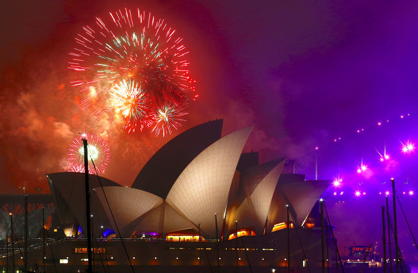 Fireworks explode near the Sydney Opera House as part of new year celebrations on Sydney Harbour, Australia, December 31, 2017 (photo credit: REUTERS/DAVID GRAY/FILE PHOTO)