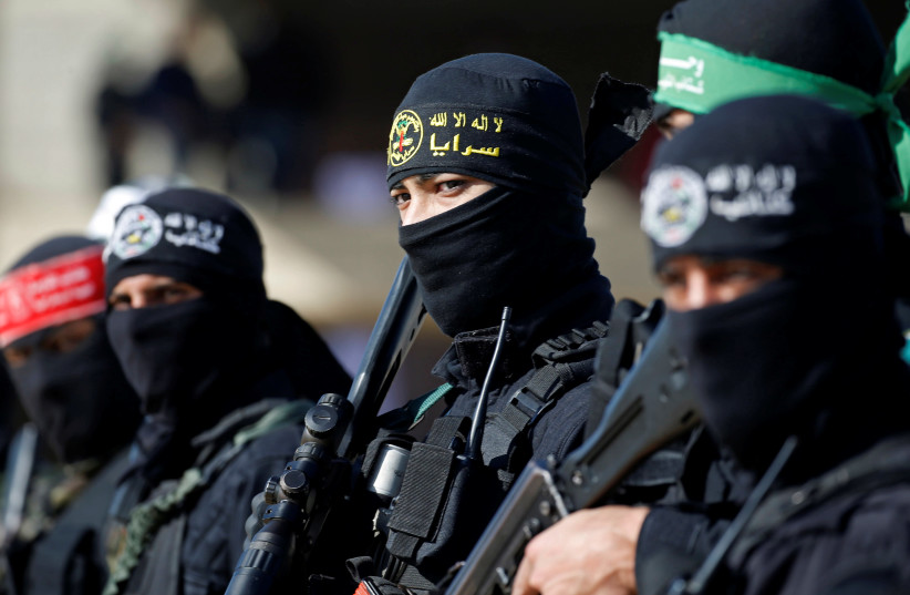 Members of Palestinian militant groups take part in their first-ever joint exercise, in Gaza City December 29, 2020 (photo credit: REUTERS/MOHAMMED SALEM)