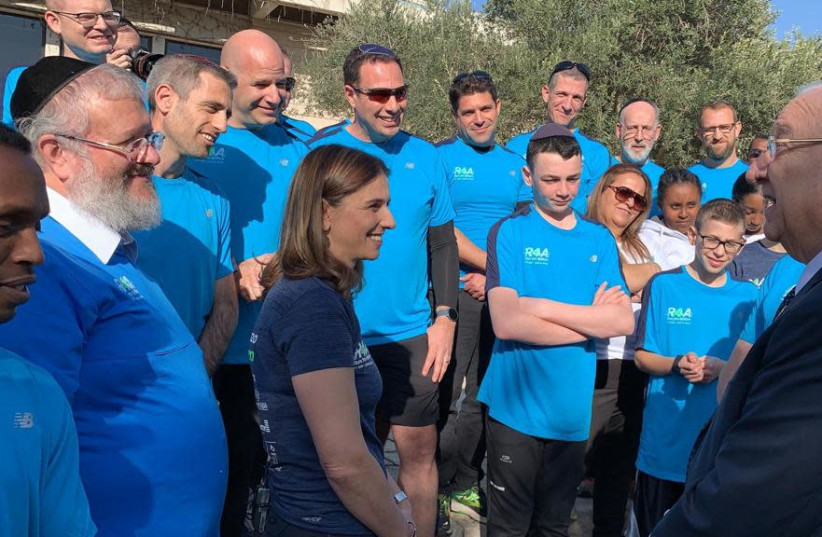 Afikim CEO Moshe Lefkowitz and co-founder of Run4Afikim Gila Rockman with the participants of the race at a meeting with President Reuven Rivlin, 2019.  (photo credit: COURTESY AFIKIM)