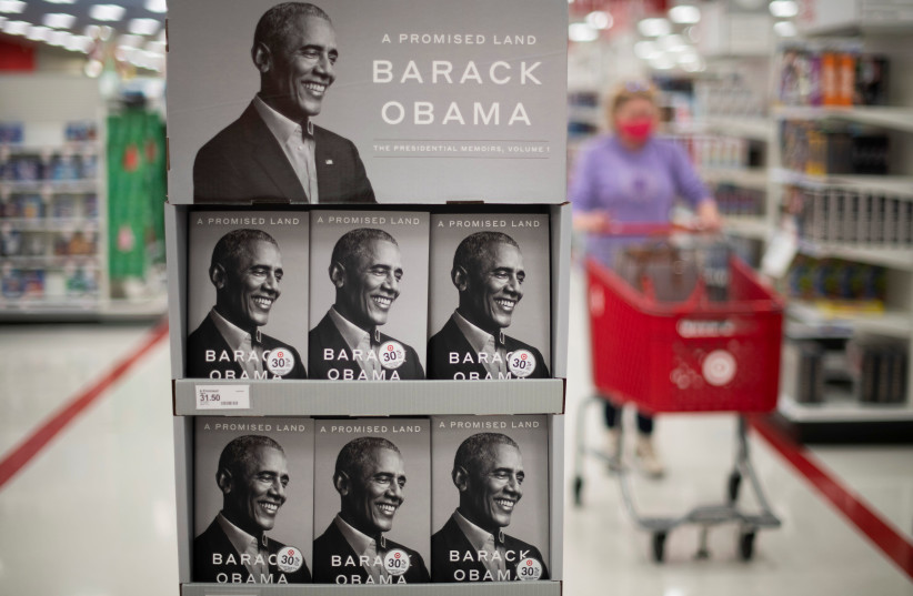 A shopper walks past a display of former US president Barack Obama’s newly released autobiography at a Target store in King of Prussia, Pennsylvania. (photo credit: MARK MAKELA / REUTERS)