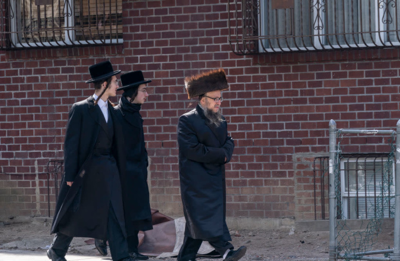 Satmar Jewish men walking in a Brooklyn neighborhood (credit: LEV RADIN/PACIFIC PRESS/LIGHTROCKET VIA GETTY IMAGES)