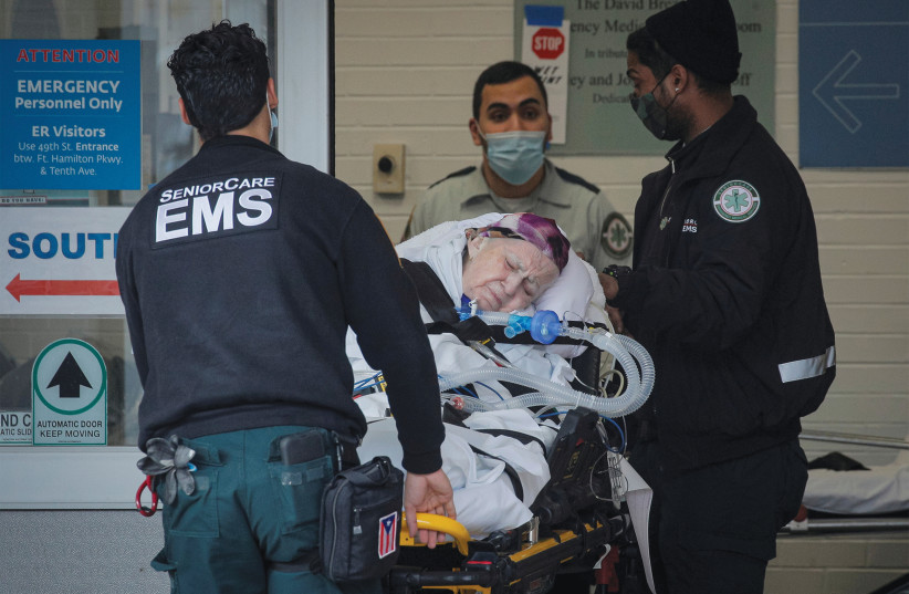 EMS WORKERS bring a patient to Maimonides Medical Center in Brooklyn, New York City, last month. (Brendan McDermid/Reuters) (photo credit: BRENDAN MCDERMID/REUTERS)