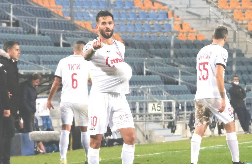 HAPOEL HAIFA midfielder Hanan Maman celebrates after his 82nd-minute goal – his second tally of the game – gave his team a 3-3 draw against Beitar Jerusalem (inset) on Saturday night in Premier League action at Teddy Stadium. (Danny Maron) (photo credit: DANNY MARON)