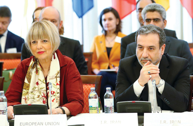 IRANIAN NUCLEAR negotiator Abbas Araqchi and EEAS Secretary-General Helga Schmid attend a meeting of the JCPOA Joint Commission in Vienna, Austria, in 2019. (photo credit: LEONHARD FOEGER / REUTERS)