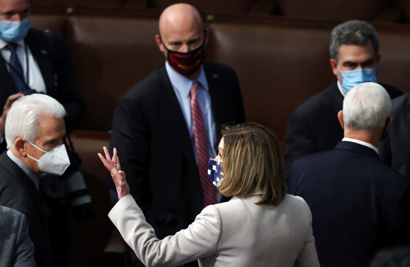 House Speaker Nancy Pelosi gestures after the Congress certified the Electoral College votes of the 2020 presidential election, in US Capitol in Washington, US January 7, 2021. (photo credit: REUTERS/JONATHAN ERNST)