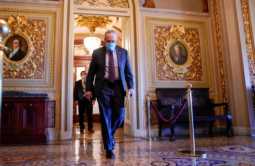 US Senate Minority Leader Chuck Schumer (D-NY) walks through the US Capitol in Washington, US, December 17, 2020. (photo credit: REUTERS/ERIN SCOTT)