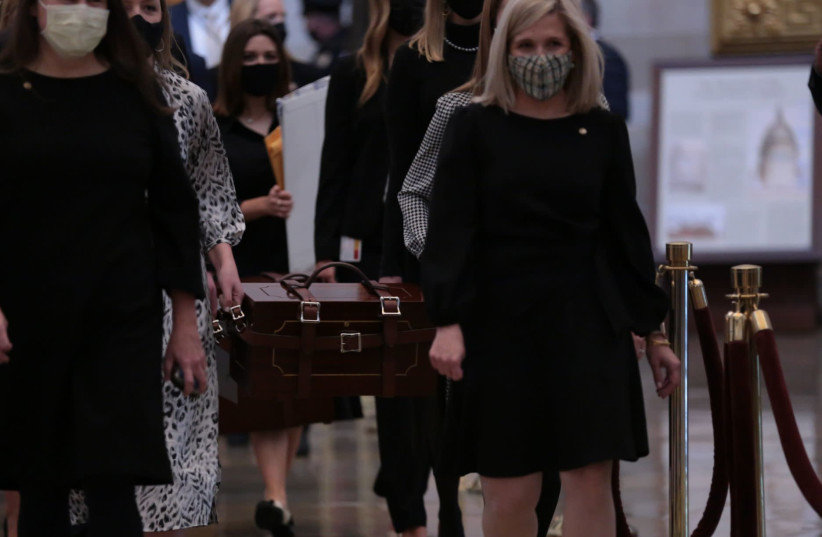 US Senate staff carry boxes containing state Electoral College votes at the US Capitol, Jan. 6, 2021. Brennan Leach, a Northwestern student whose photo went viral, is second from left, partially obscured.  (photo credit: CHERISS MAY/GETTY IMAGES)