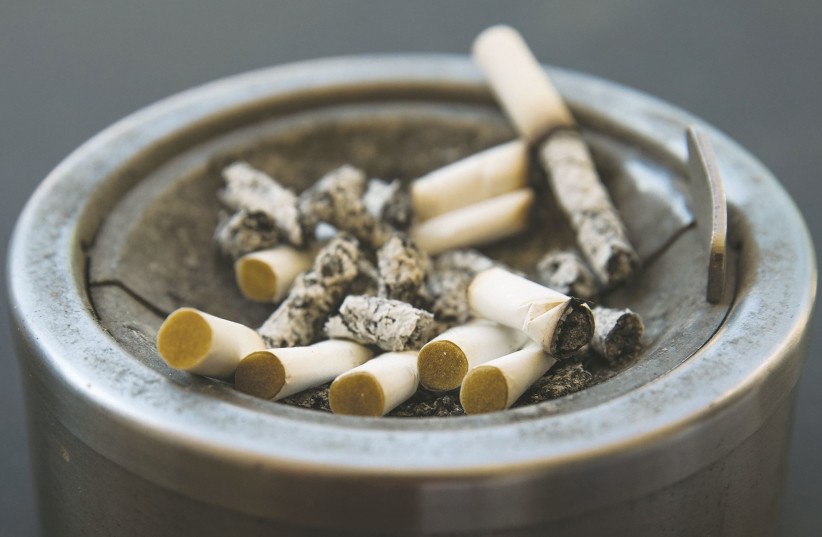 Illustration of cigarettes in an ashtray. (credit: NATI SHOHAT/FLASH90)