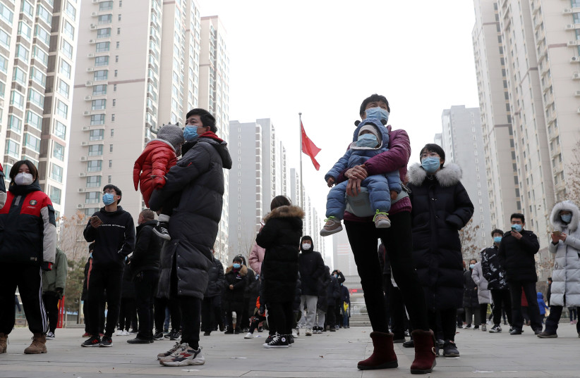 People line up for a second round of citywide nucleic acid testing at a residential compound in Shijiazhuang (photo credit: REUTERS)