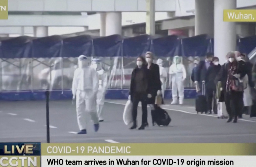 Still image of WHO team tasked with investigating the origins of the coronavirus disease (COVID-19) pandemic arriving at Wuhan Tianhe International Airport (photo credit: REUTERS)