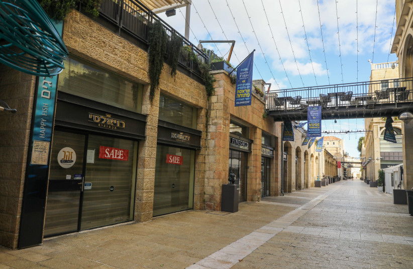 Stores in Jerusalem's Mamilla mall are seen closed amid the ongoing coronavirus lockdown, on January 14, 2021. (photo credit: MARC ISRAEL SELLEM/THE JERUSALEM POST)