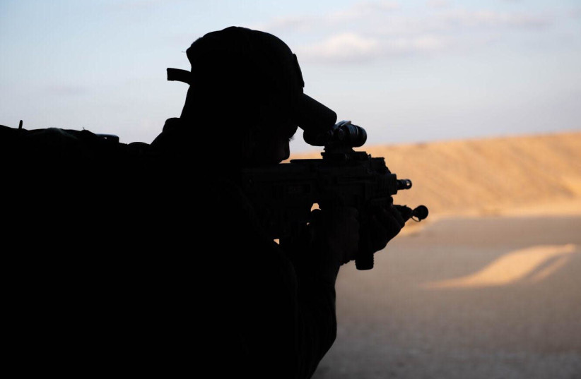A soldier in the IDF's Unit 585 is seen holding a gun facing the desert. (photo credit: IDF SPOKESPERSON'S UNIT)