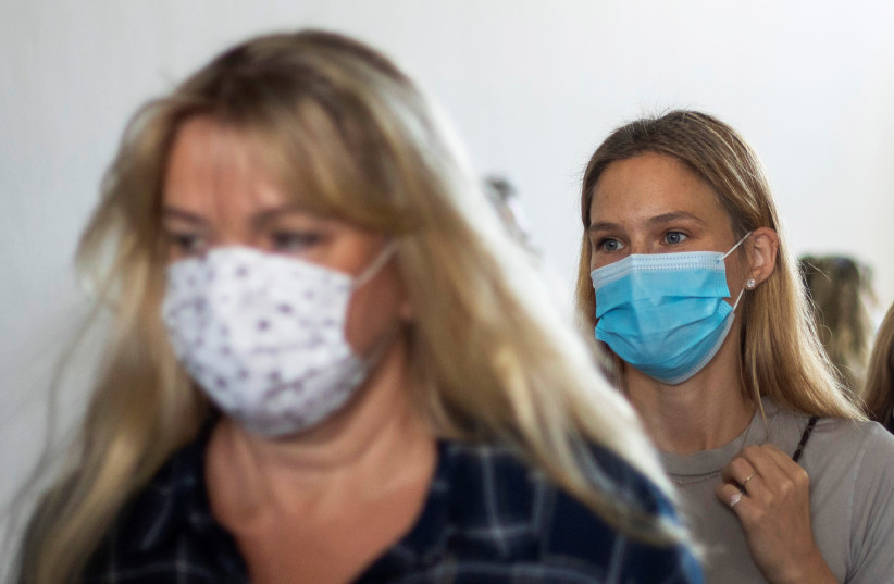 Israeli model Bar Refaeli wears a face mask amid the coronavirus disease (COVID-19) pandemic as she leaves the courtroom with her mother, in Tel Aviv, Israel September 13, 2020. (photo credit: ARIEL SCHALIT/POOL VIA REUTERS)