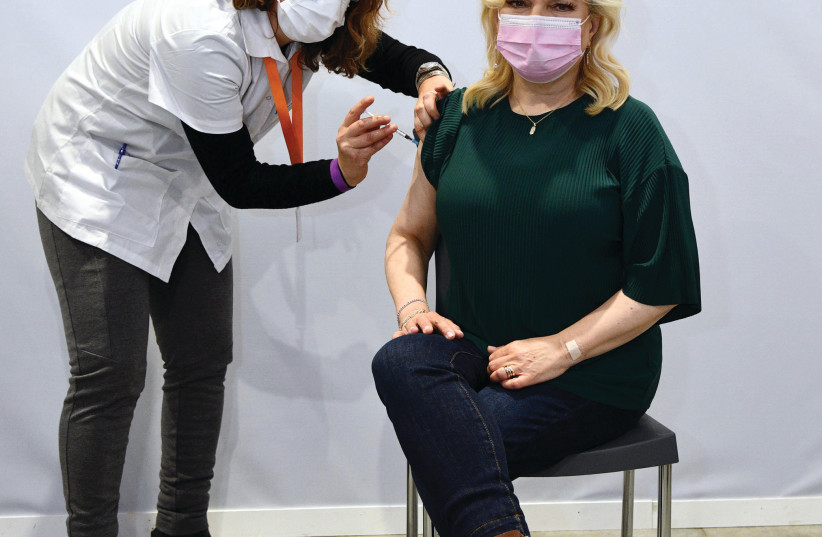 Sara Netanyahu receives her anti-COVID-19 vaccination at the Meuhedet clinic set up at the Jerusalem International Convention Center. (photo credit: HAIM ZACH/GPO)